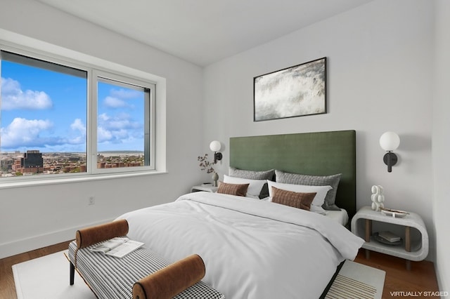 bedroom featuring baseboards and wood finished floors