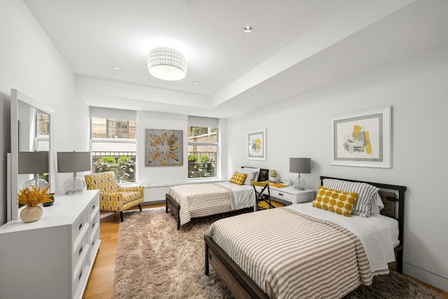 bedroom with light wood-style floors and recessed lighting