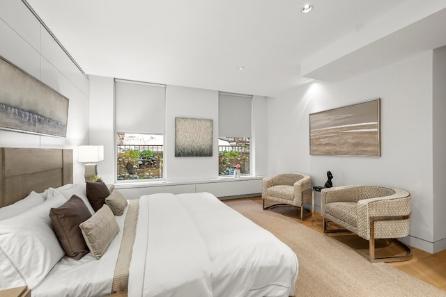 bedroom with light wood-style floors and recessed lighting