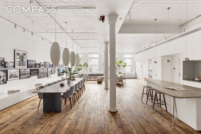 22 E 18th St Unit 4E, New York City, NY 10003 - dining room featuring decorative columns and hardwood / wood-style floors