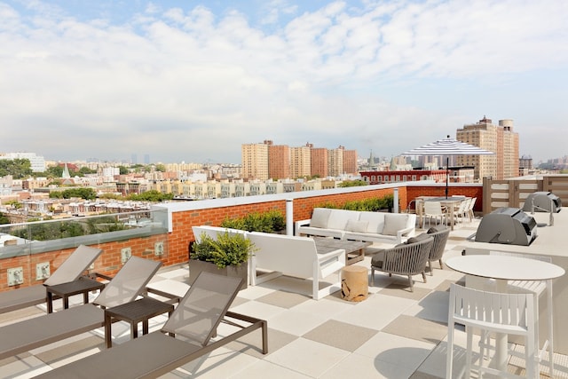 view of patio / terrace with an outdoor hangout area and a city view