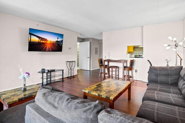 living room featuring dark hardwood / wood-style floors and a notable chandelier