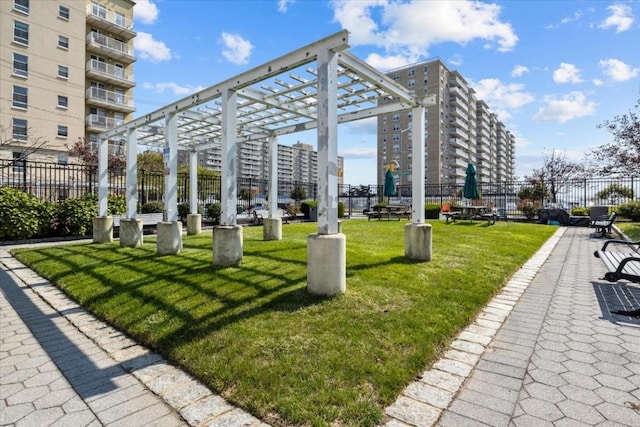 view of community featuring a lawn and a pergola