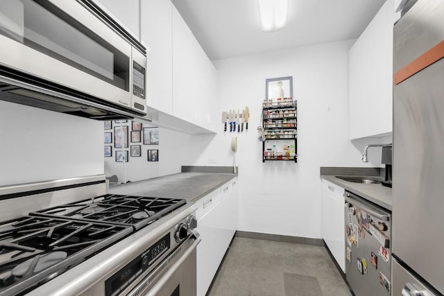 kitchen with white cabinetry, stainless steel appliances, and sink