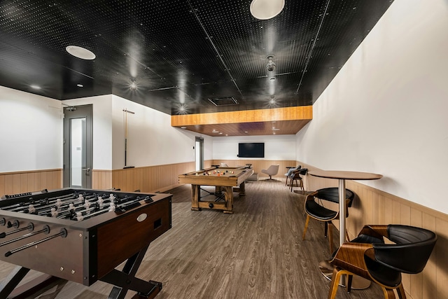 recreation room featuring pool table, wood finished floors, a wainscoted wall, and wood walls