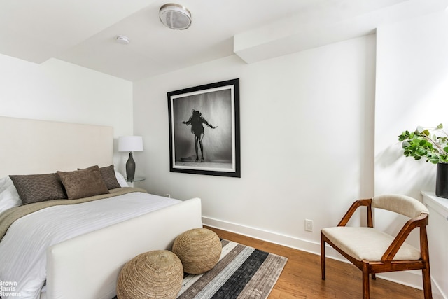 bedroom featuring wood finished floors and baseboards