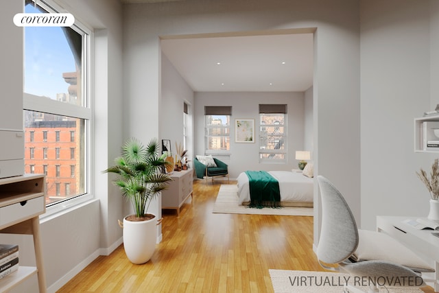 bedroom featuring light wood-type flooring and baseboards