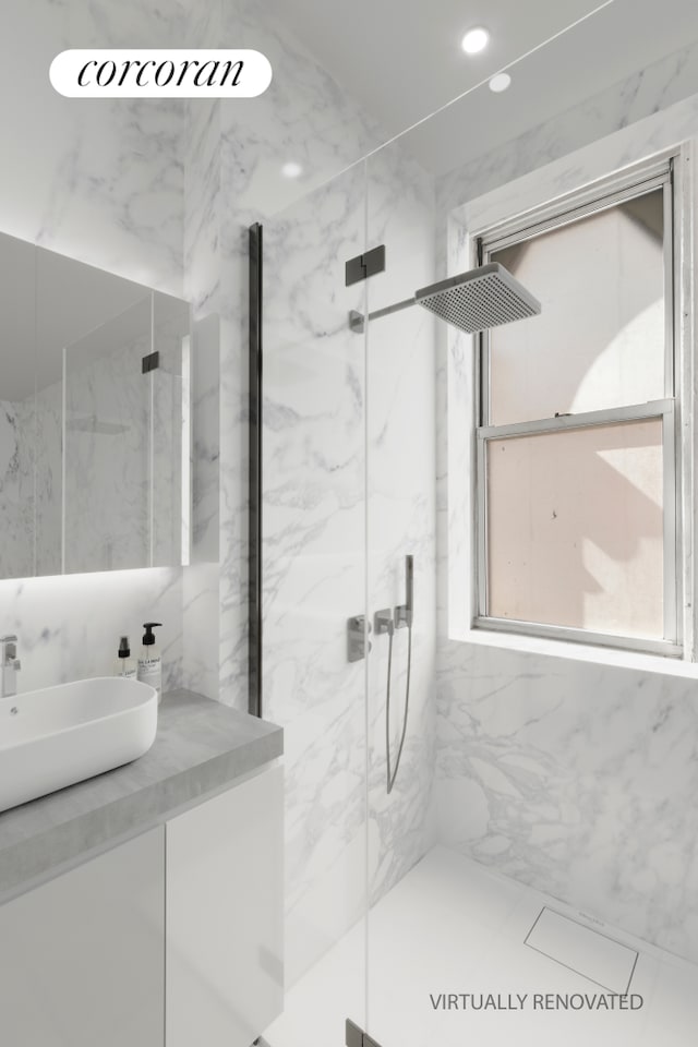 full bath with a marble finish shower, vanity, and recessed lighting