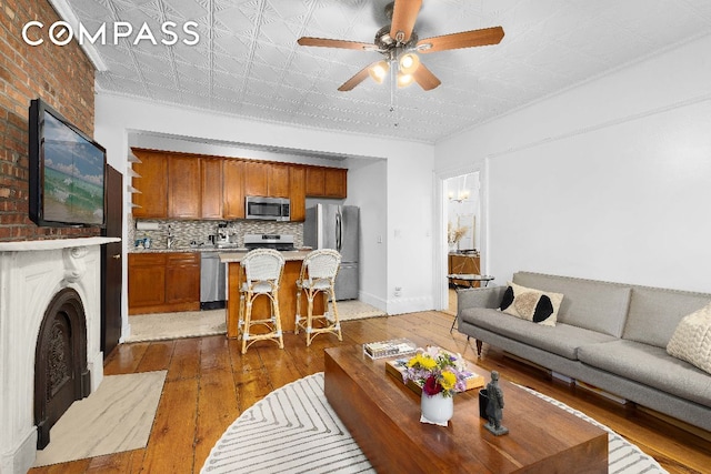 living room with dark hardwood / wood-style floors and ceiling fan