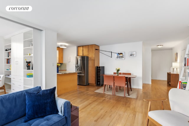 living area with visible vents and light wood finished floors