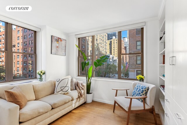 living area featuring a view of city, visible vents, and wood finished floors