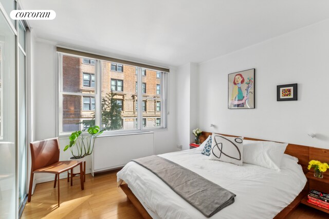 bedroom featuring visible vents and wood finished floors