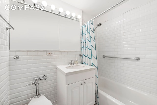 full bath featuring shower / bathtub combination with curtain, tile walls, and vanity