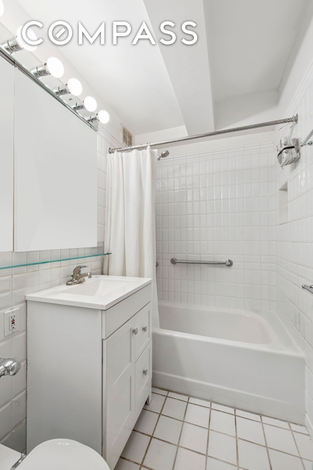 bathroom featuring tile patterned flooring, shower / bath combination with curtain, vanity, and toilet