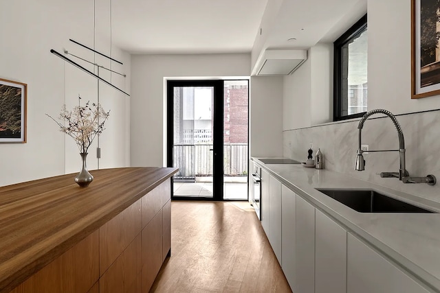 9 Chapel St Unit 8A, New York City, NY 11201 - clothes washing area featuring a sink and light wood finished floors
