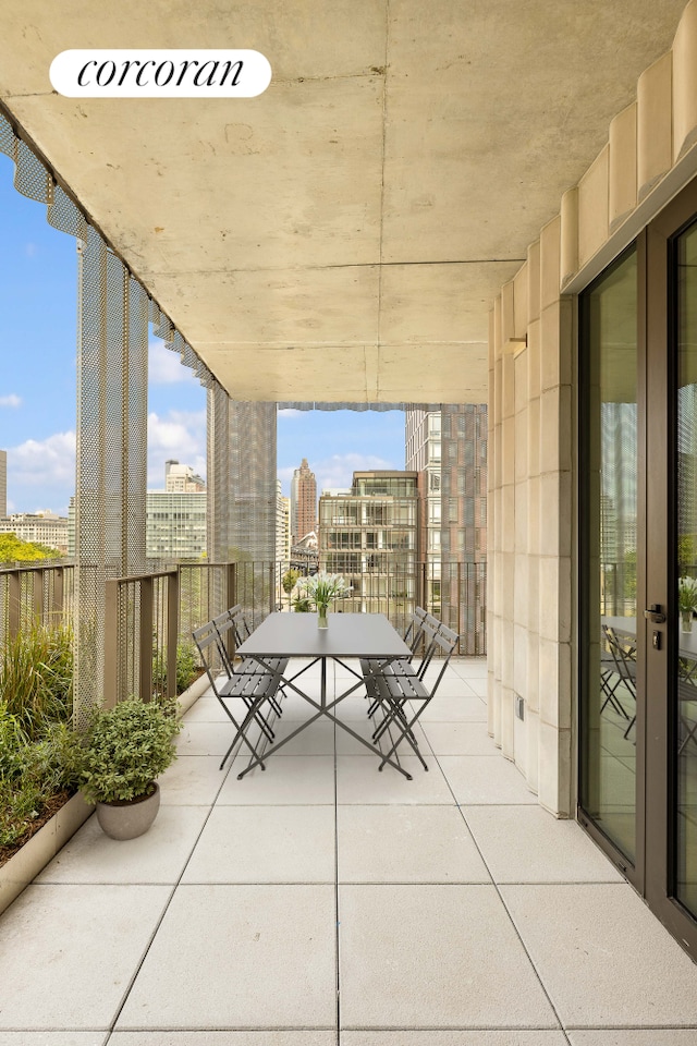 view of patio / terrace with outdoor dining space and a view of city