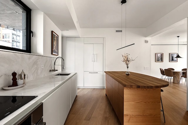 9 Chapel St Unit 8A, New York City, NY 11201 - kitchen featuring a sink, backsplash, modern cabinets, and wood finished floors