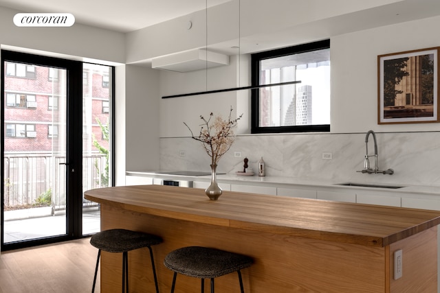 9 Chapel St Unit 8A, New York City, NY 11201 - bar featuring backsplash, light wood-type flooring, and a sink