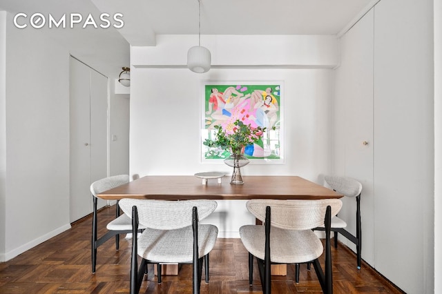 dining space with dark parquet floors