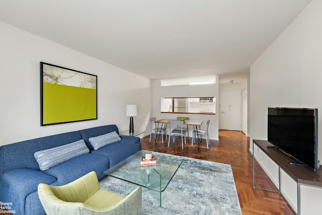 living room featuring dark parquet flooring