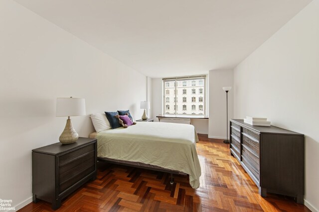 bedroom featuring parquet flooring