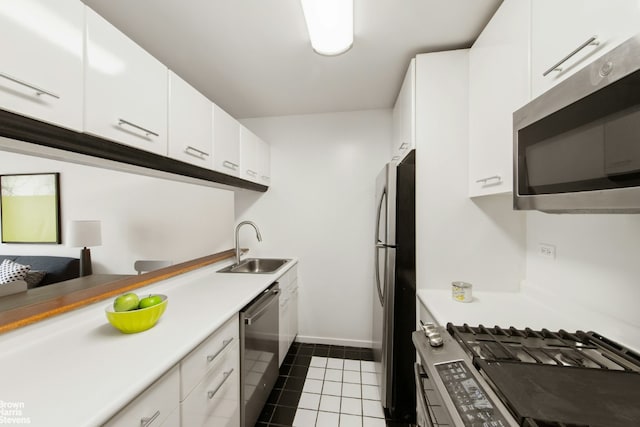 kitchen with sink, white cabinetry, tile patterned floors, and stainless steel appliances