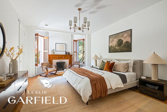 bedroom featuring a chandelier and light hardwood / wood-style floors