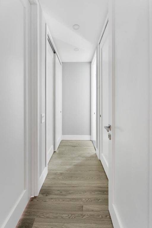 corridor with light hardwood / wood-style flooring