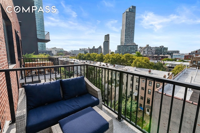 balcony featuring a city view and an outdoor living space