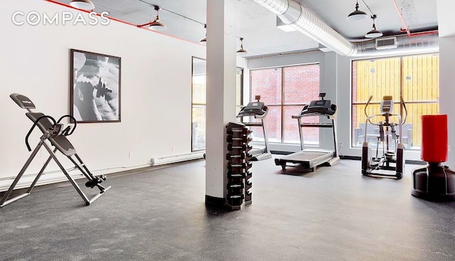 exercise area featuring visible vents and baseboards