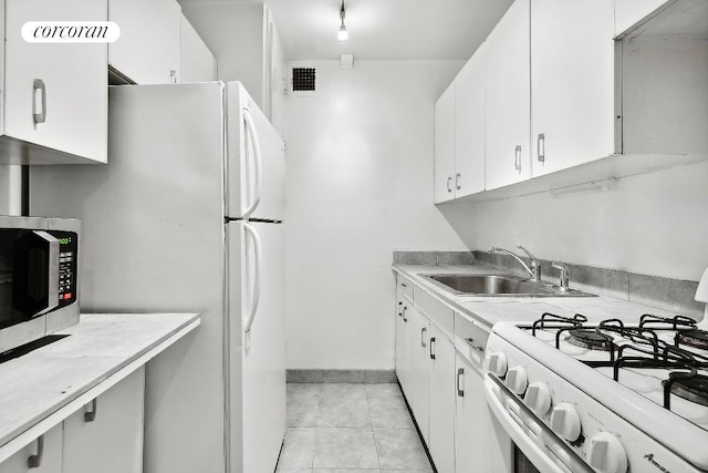 kitchen featuring sink, white appliances, and white cabinets