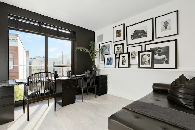 office featuring visible vents, baseboards, and wood finished floors