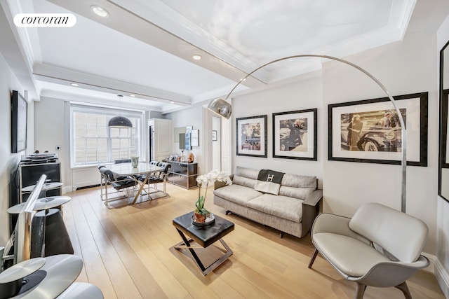 living area featuring light wood finished floors, visible vents, beam ceiling, and ornamental molding