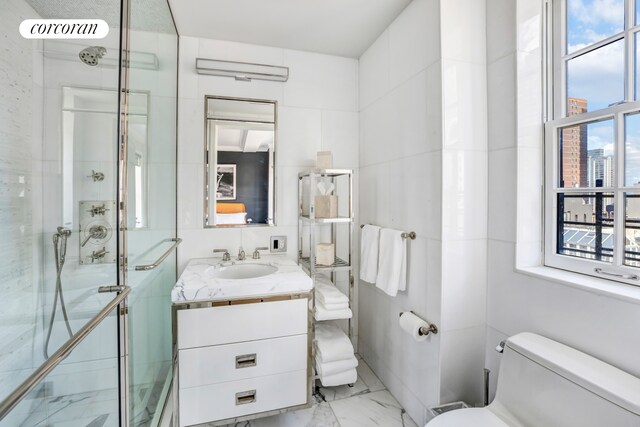 141 E 88th St Unit 10A, New York City, NY 10128 - full bathroom featuring vanity, a shower stall, and marble look tile flooring
