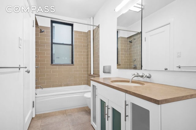 full bathroom featuring vanity, tile patterned floors, toilet, and tub / shower combination