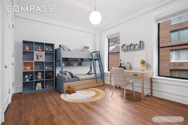 bedroom featuring baseboards and wood finished floors