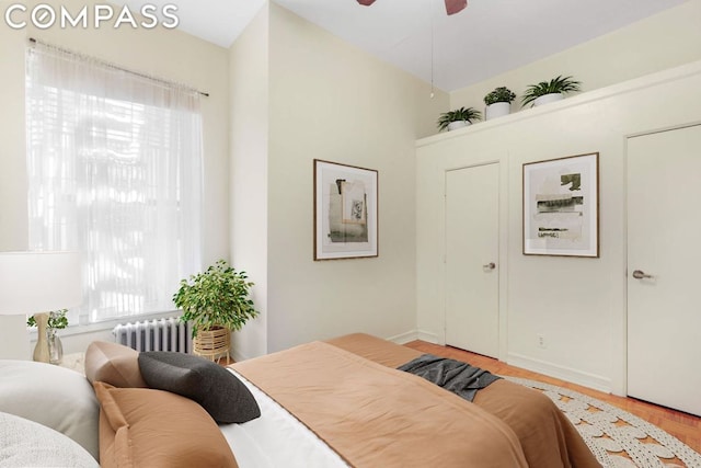 bedroom with ceiling fan and radiator