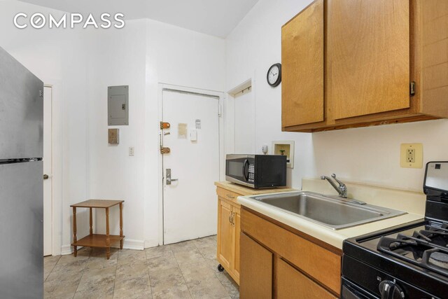 kitchen featuring sink, stainless steel appliances, and electric panel