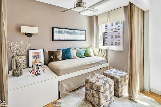 living area featuring light parquet floors and ceiling fan