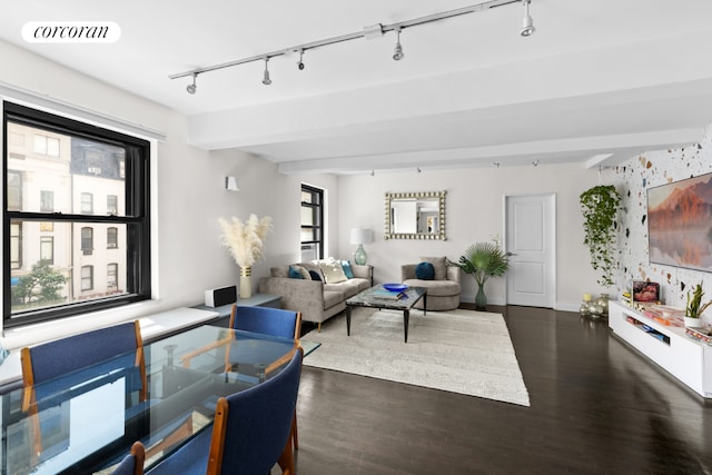 living room with beam ceiling, track lighting, and dark hardwood / wood-style floors