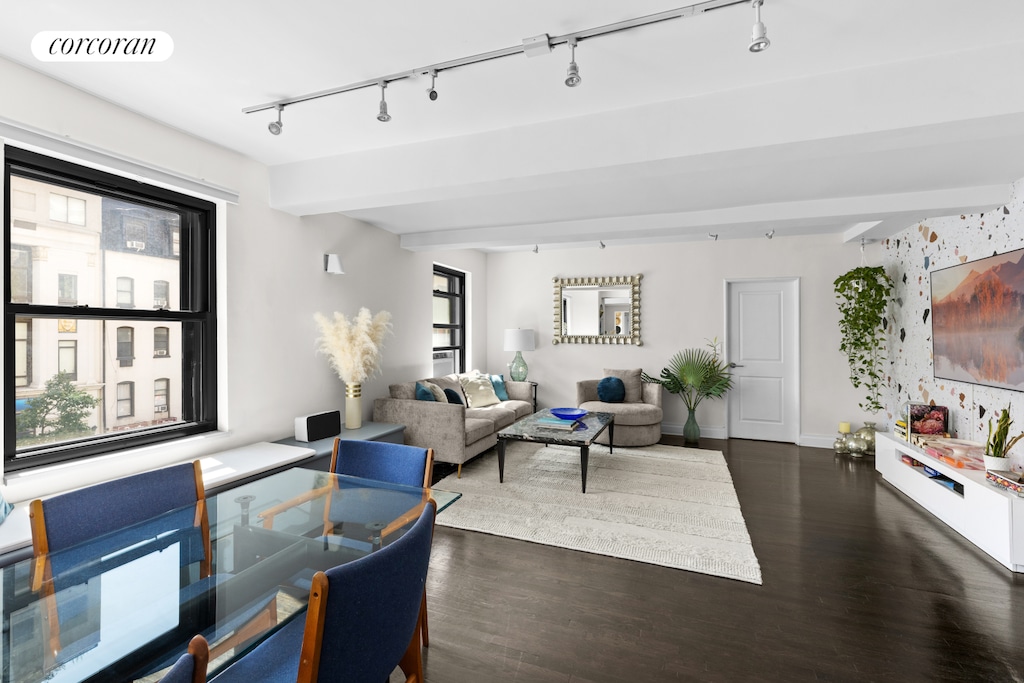 315 W 23rd St Unit 2C, New York City, NY 10011 - living area featuring visible vents, baseboards, dark wood-style floors, and track lighting