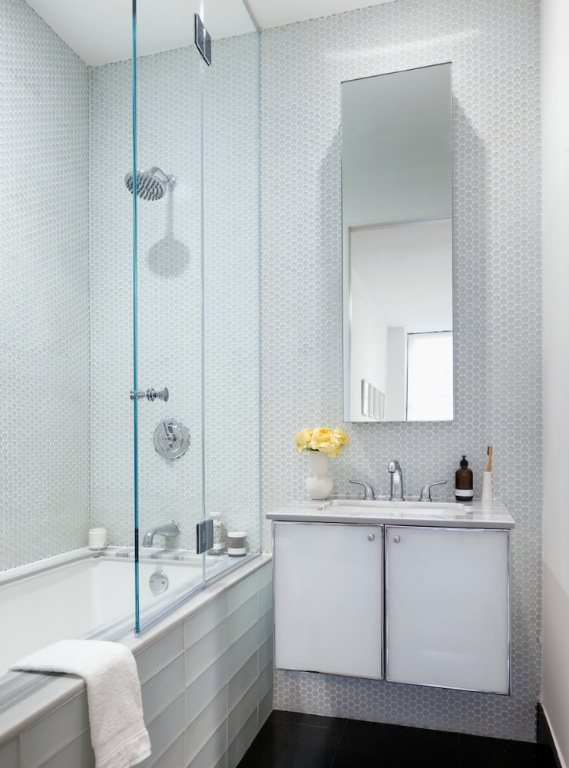 bathroom with tiled shower / bath combo, tile patterned flooring, and vanity