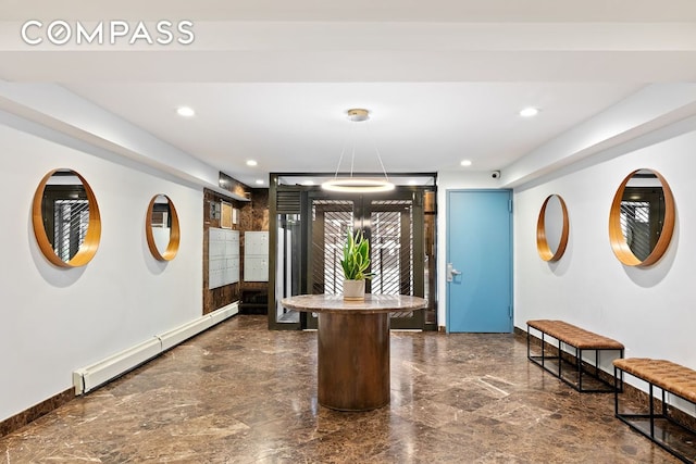 dining room featuring decorative light fixtures, a baseboard radiator, and a kitchen island