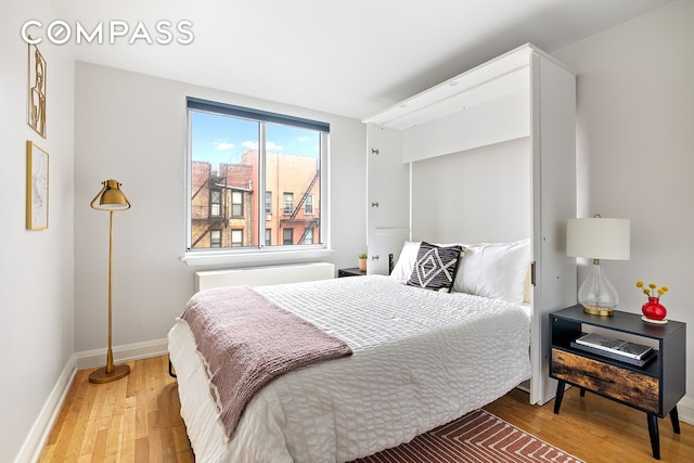 bedroom featuring light wood-style flooring and baseboards