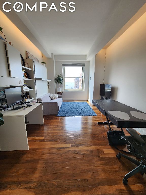 office space with dark wood-type flooring