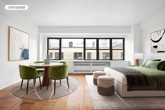 bedroom featuring radiator, parquet flooring, and multiple windows