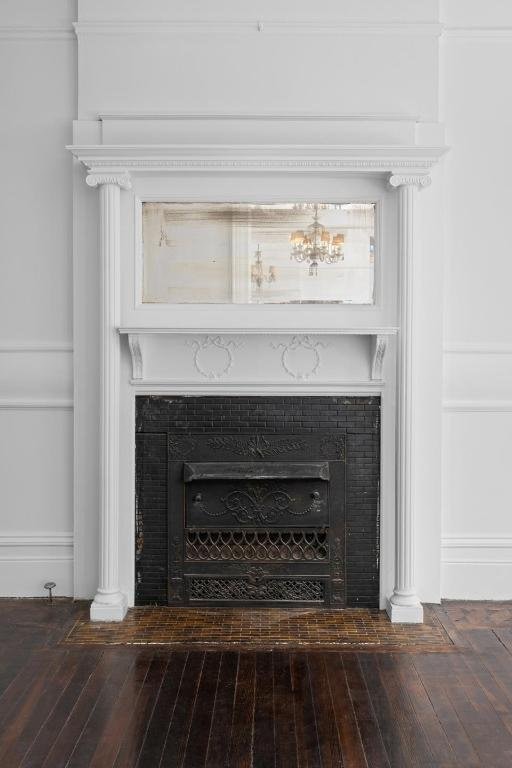 interior details with a fireplace and wood-type flooring