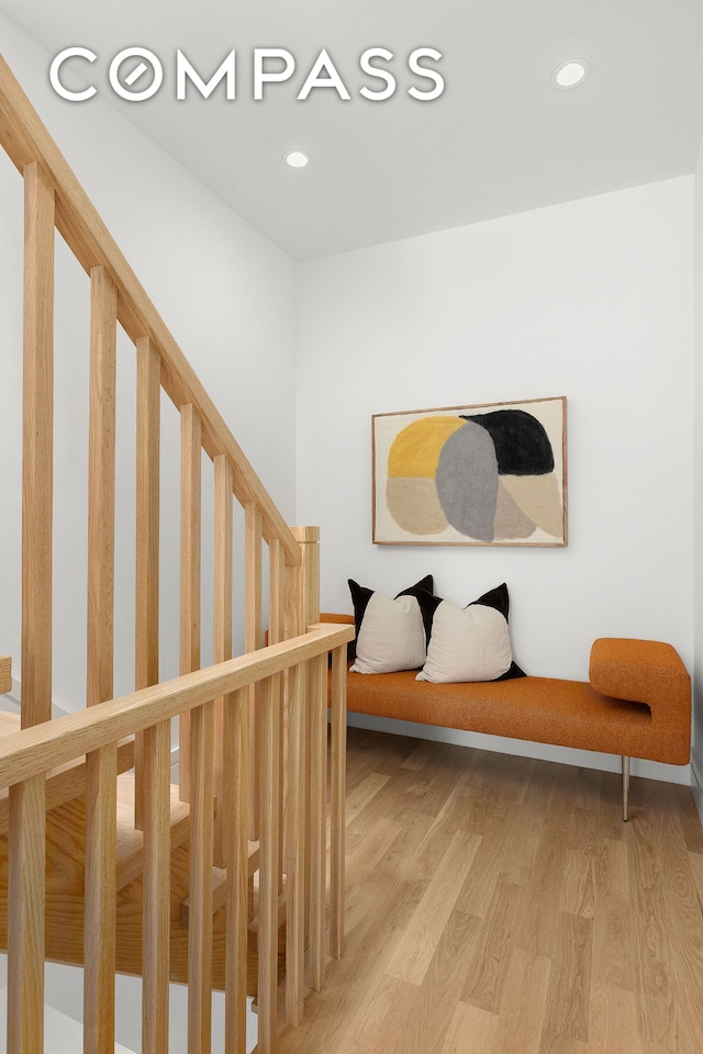 stairs featuring recessed lighting and wood finished floors