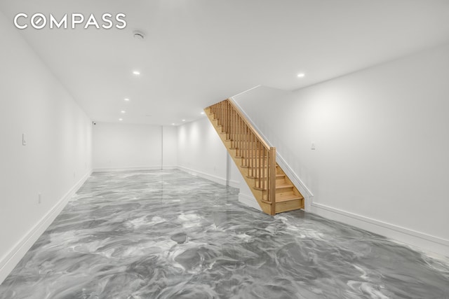 finished basement featuring recessed lighting, stairway, and baseboards