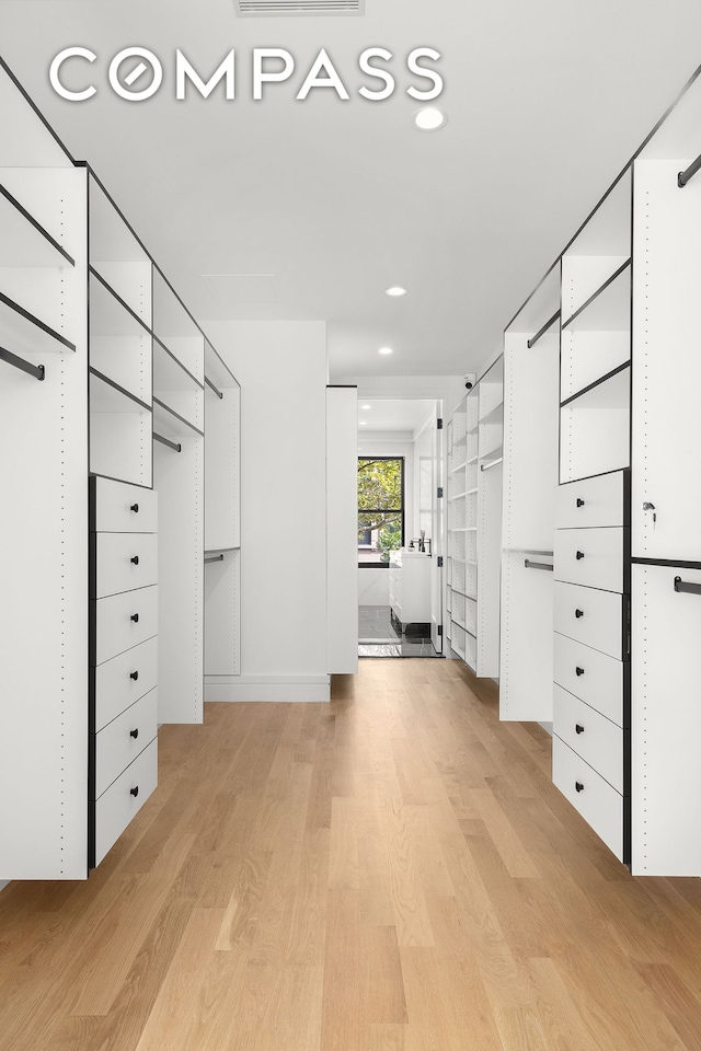 spacious closet with light wood-style floors